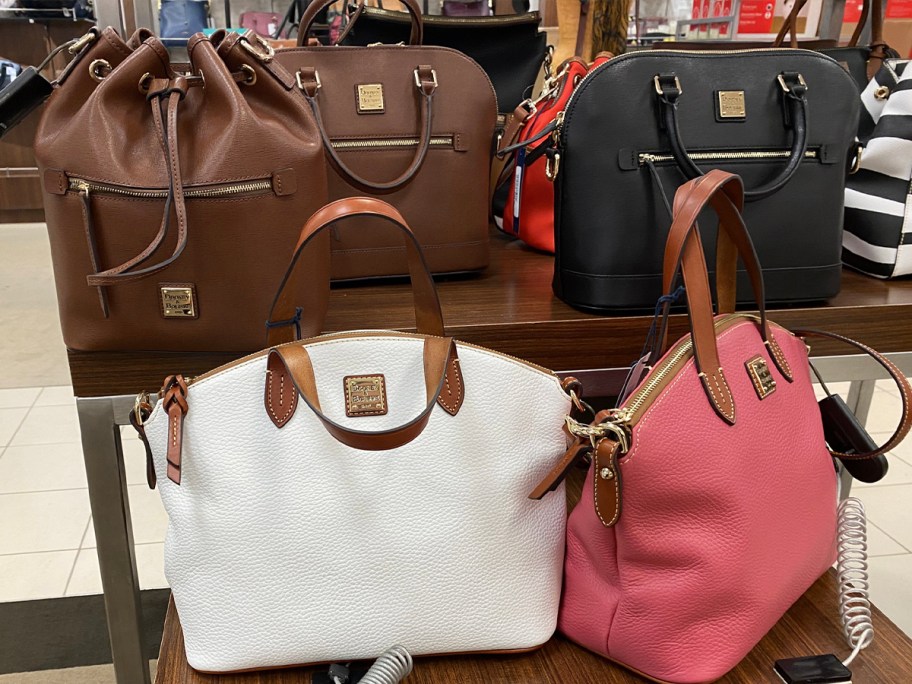 dooney and burke handbags on table