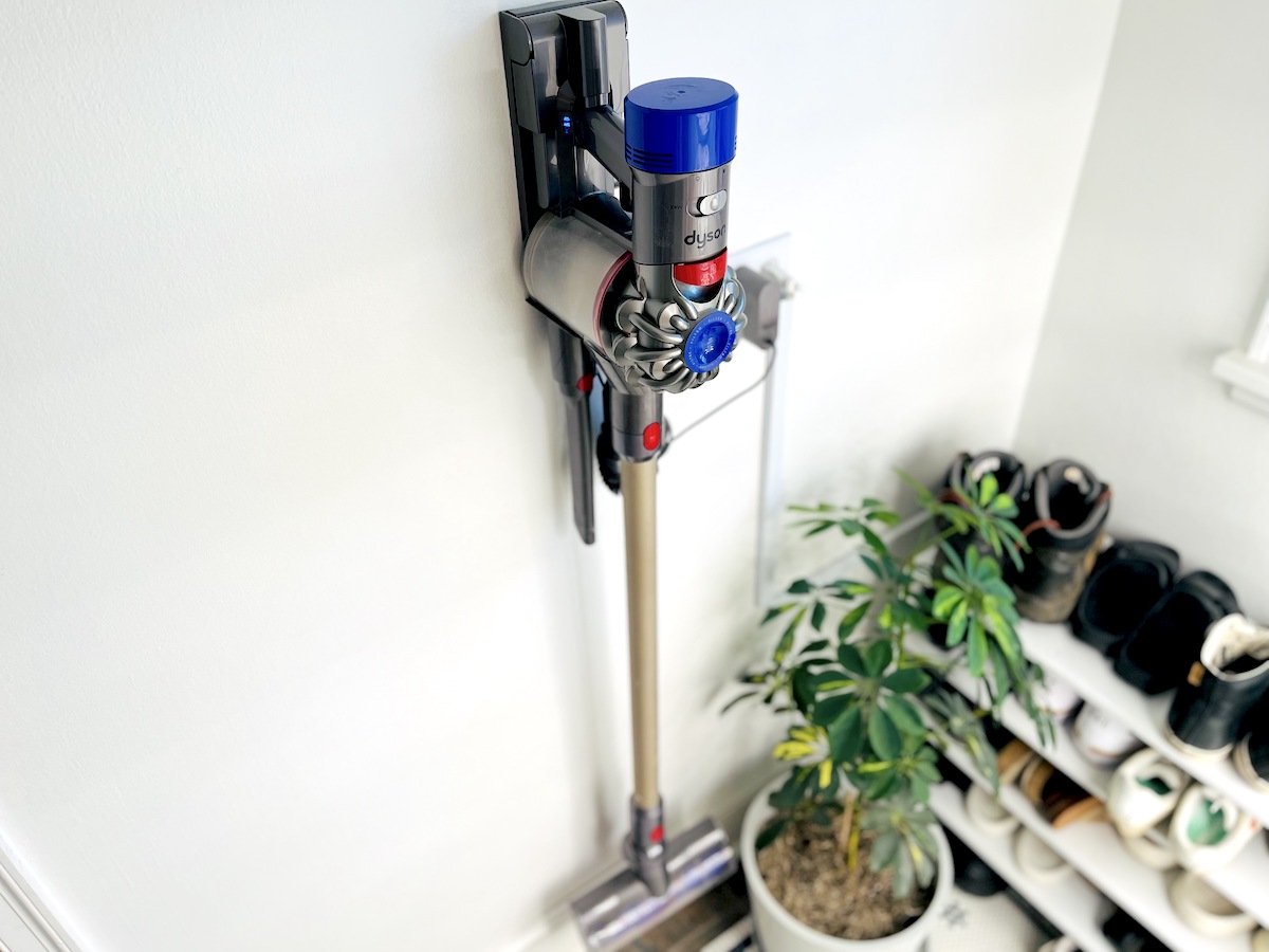 cordless dyson vacuum hanging on wall