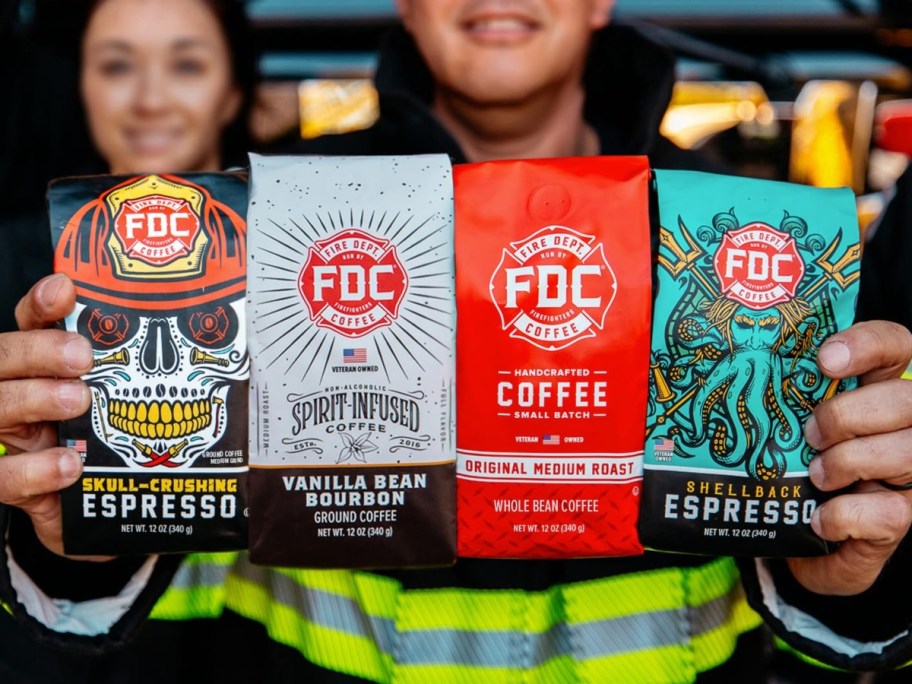 fire fighter holding 4 bags of coffee