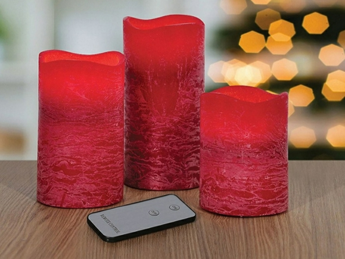 three red candles on table
