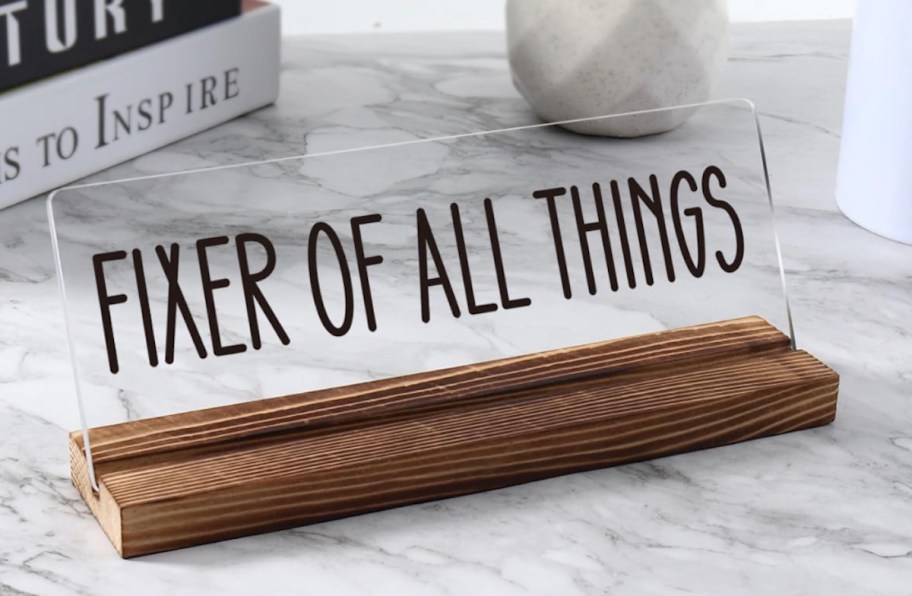 fixer of all things clear acrylic wood stand sign on marble table