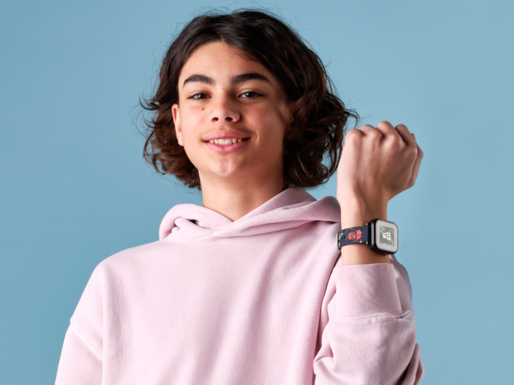 kid holding up wrist with smart watch