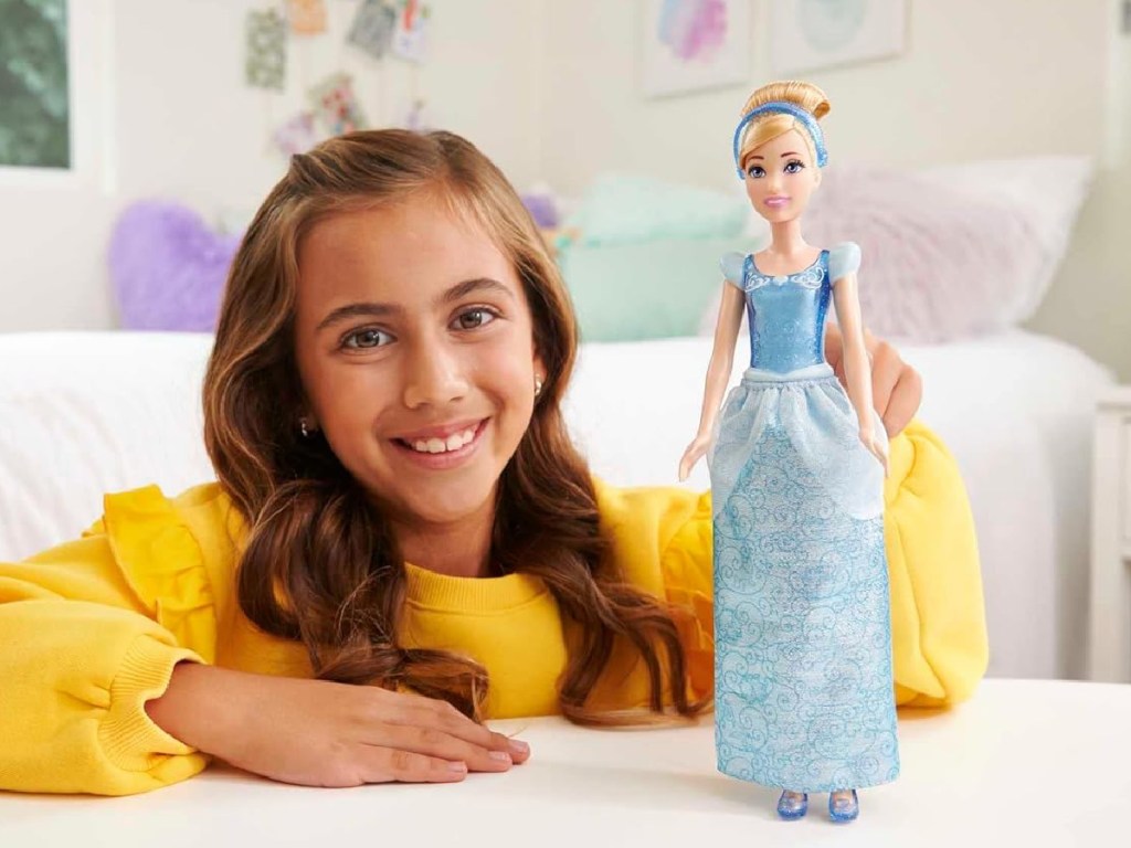 girl playing with Mattel Disney Princess Dolls - Cinderella
