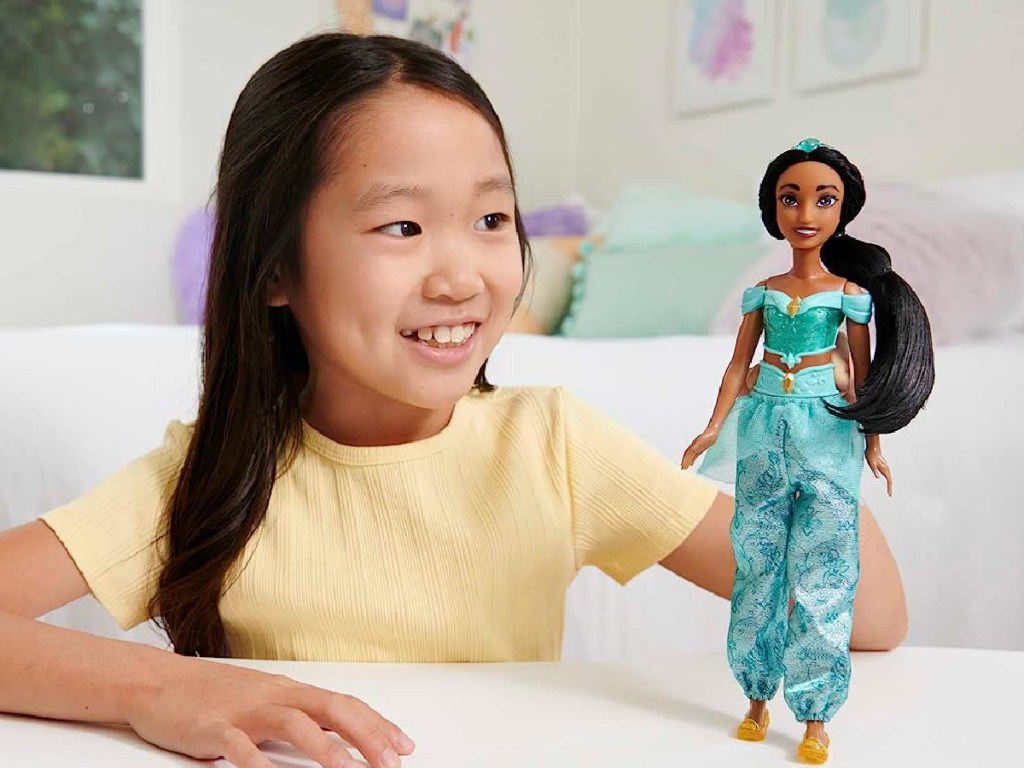 girl playing with Mattel Disney Princess Dolls - Jasmine