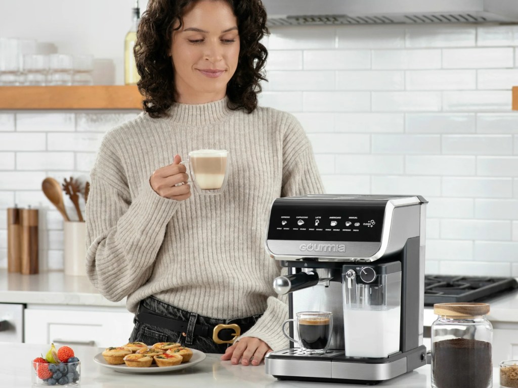 woman drinking cappuccino in kitchen