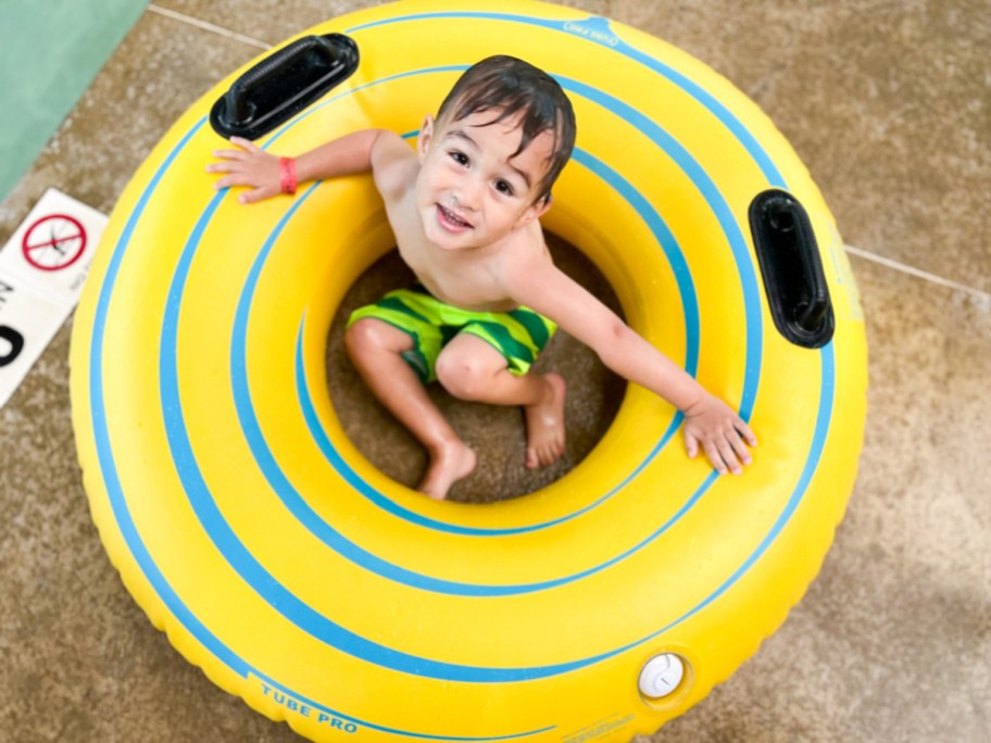 little boy in yellow floatie ring