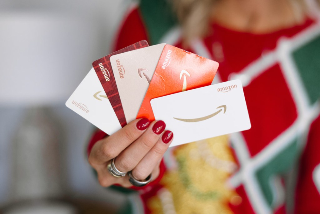 hand holding amazon gift cards