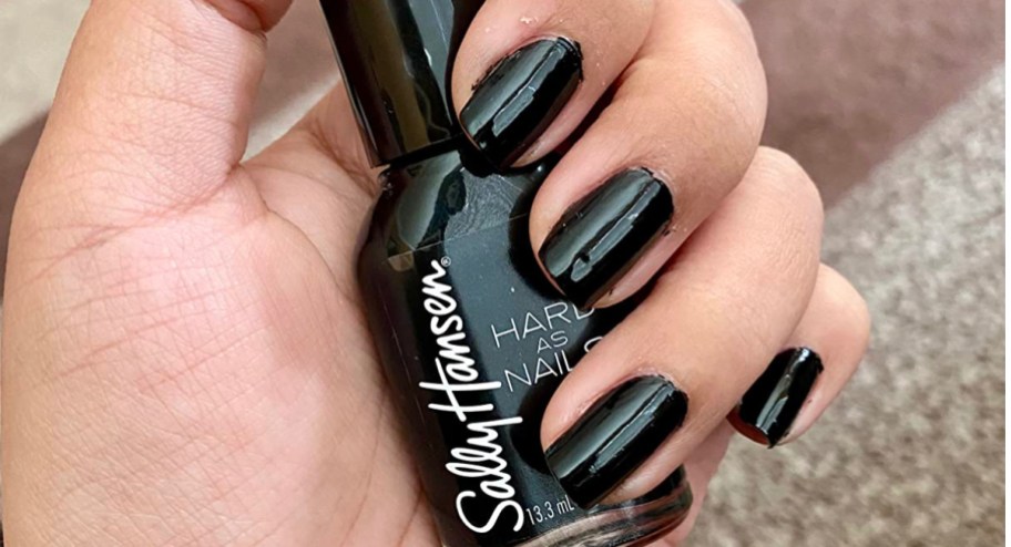 hand holding sally handset nail polish in black