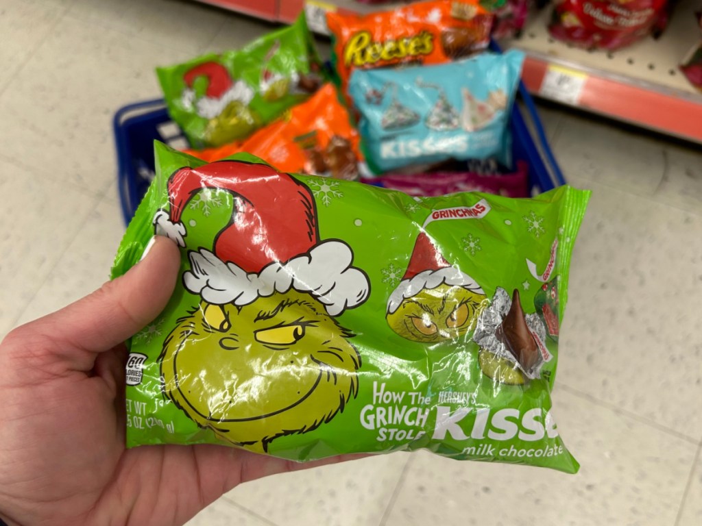 Person holding up how the Grinch stole Christmas Hershey's kisses candy bag at Walgreens