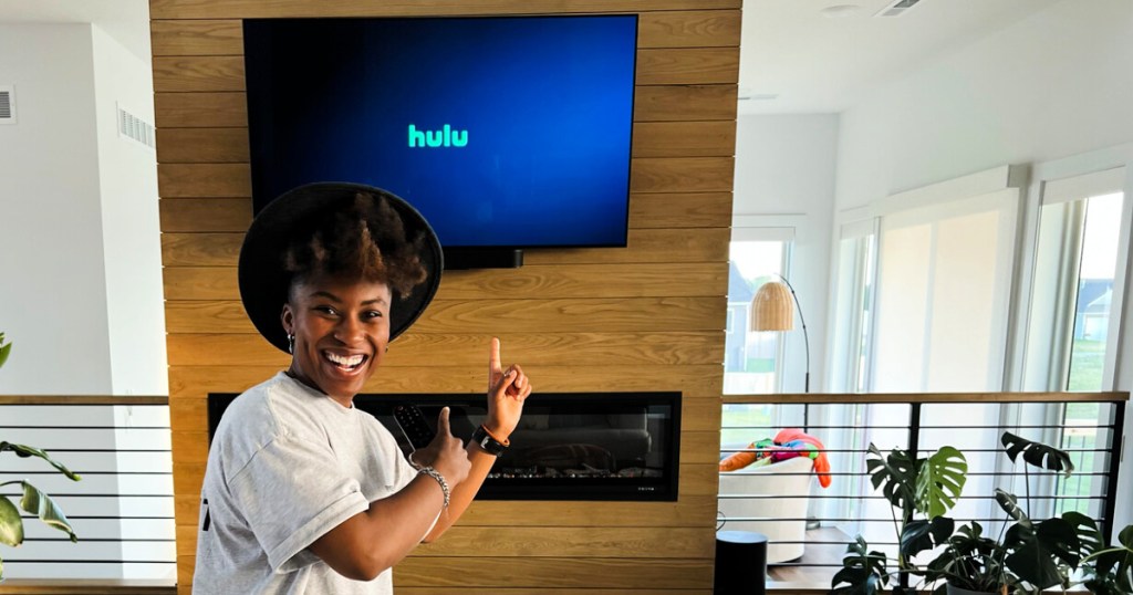 woman pointing at a screen featuring the Hulu logo
