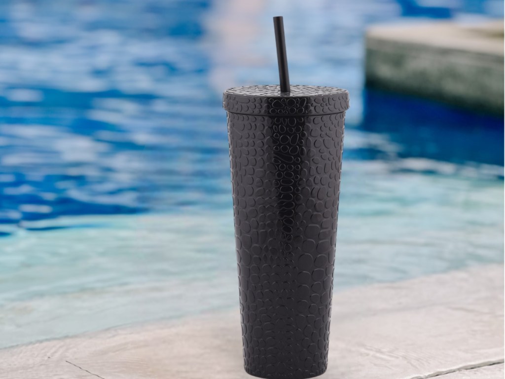 images of black tumbler in front of water