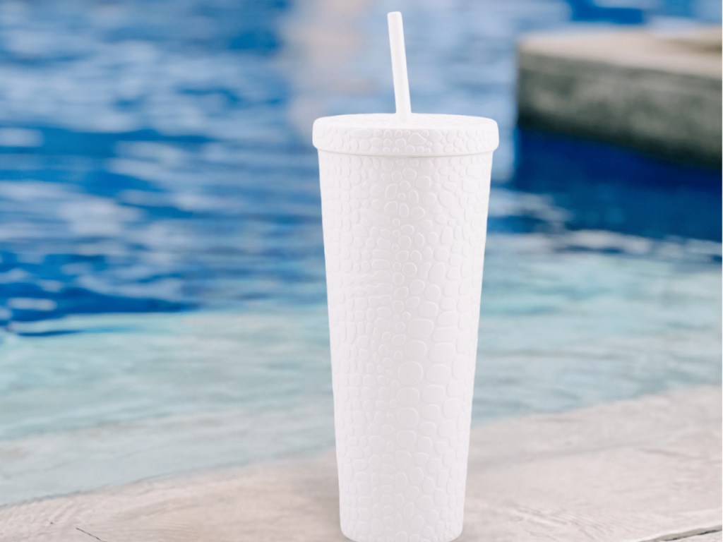 images of white tumbler in front of water