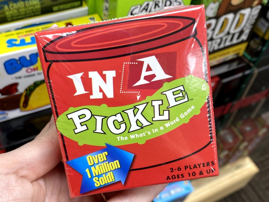 holding a boxed In A Pickle game