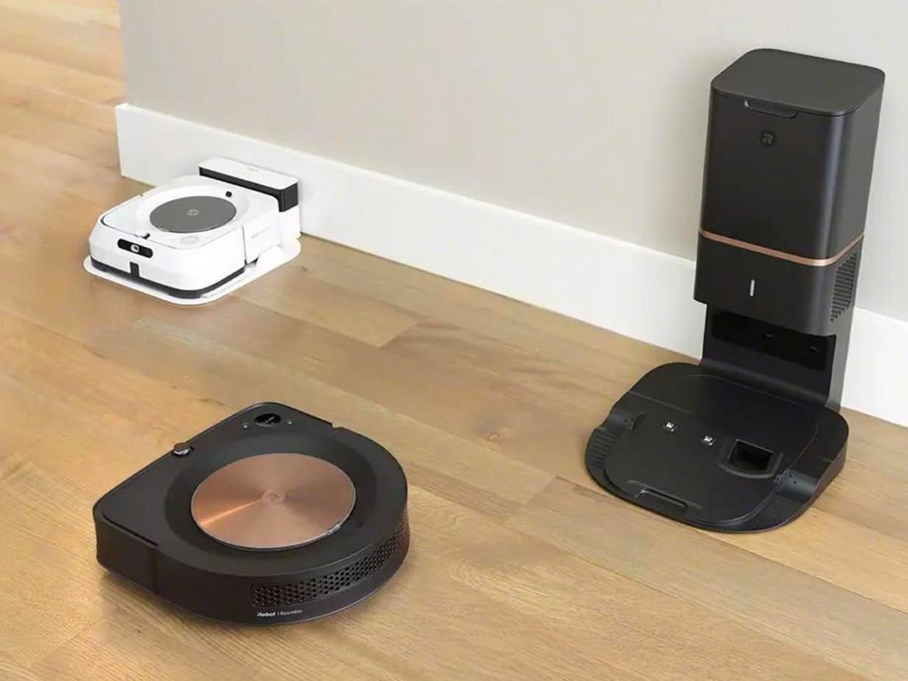 black irobot vacuum and white mop on hardwood floor