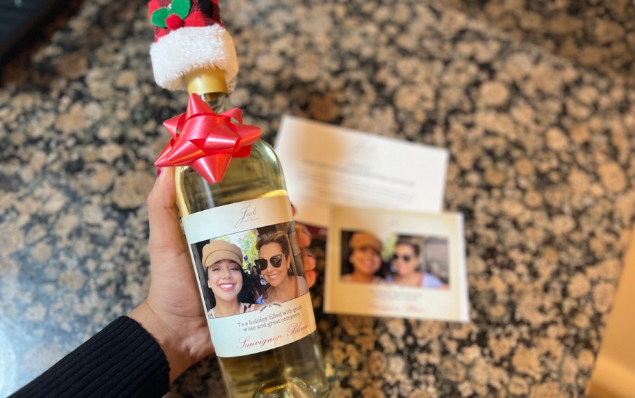 hand holding bottle of white wine with custom photo free label