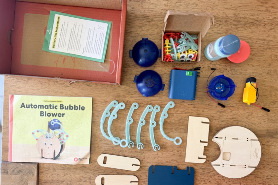 wooden and plastic parts for bubble machine organized on table