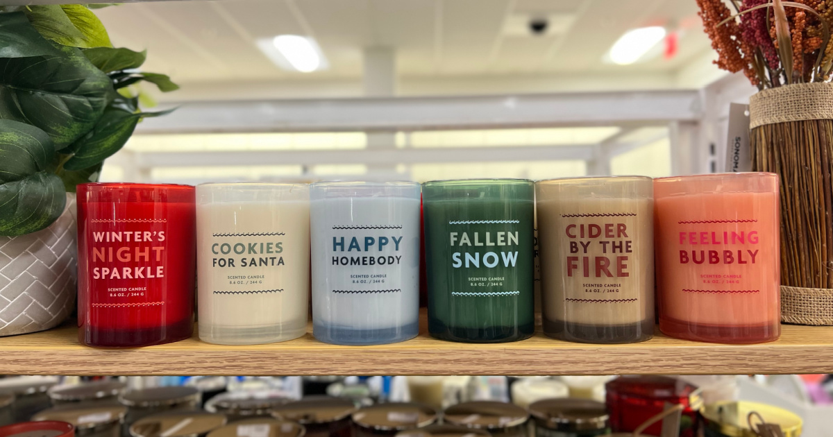glass jar candles with winter and christmas names lined up on a kohls store shelf