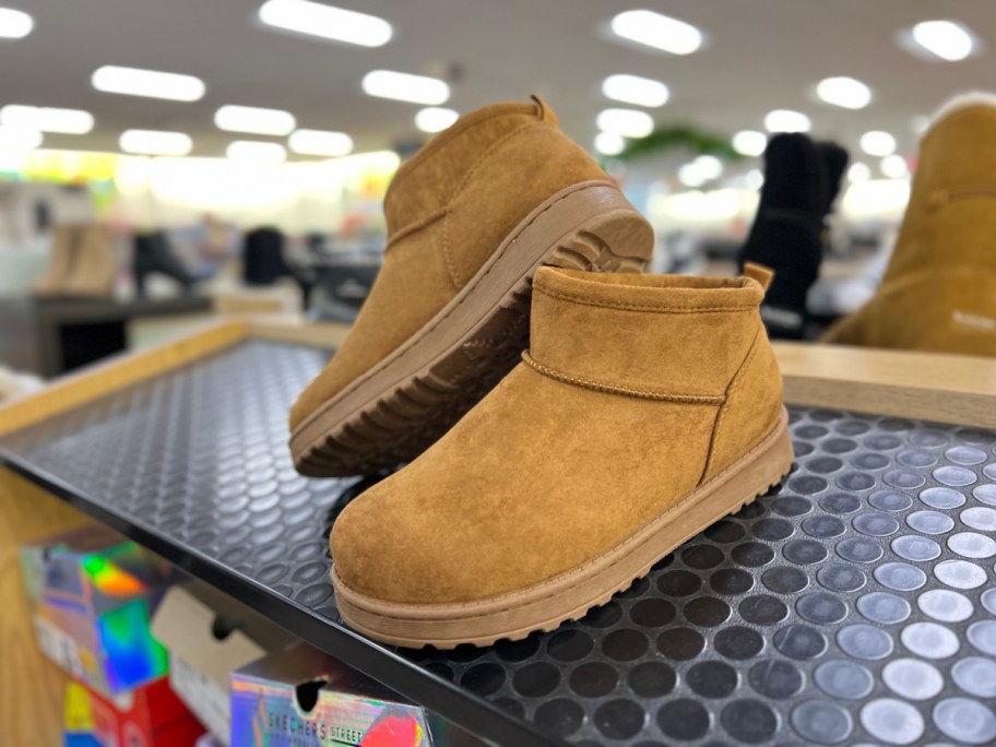 pair of cozy boots on display on a kohls shelf