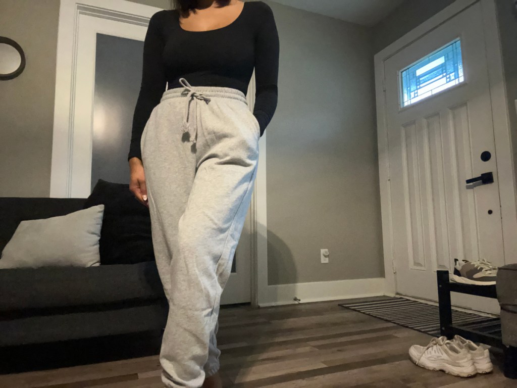 woman wearing a bodysuit and a pair of kohls joggers