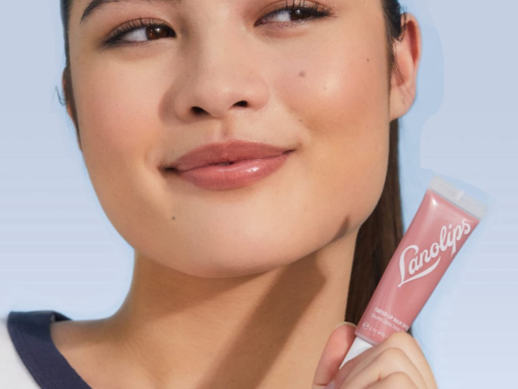 woman holding a tube of lanolips