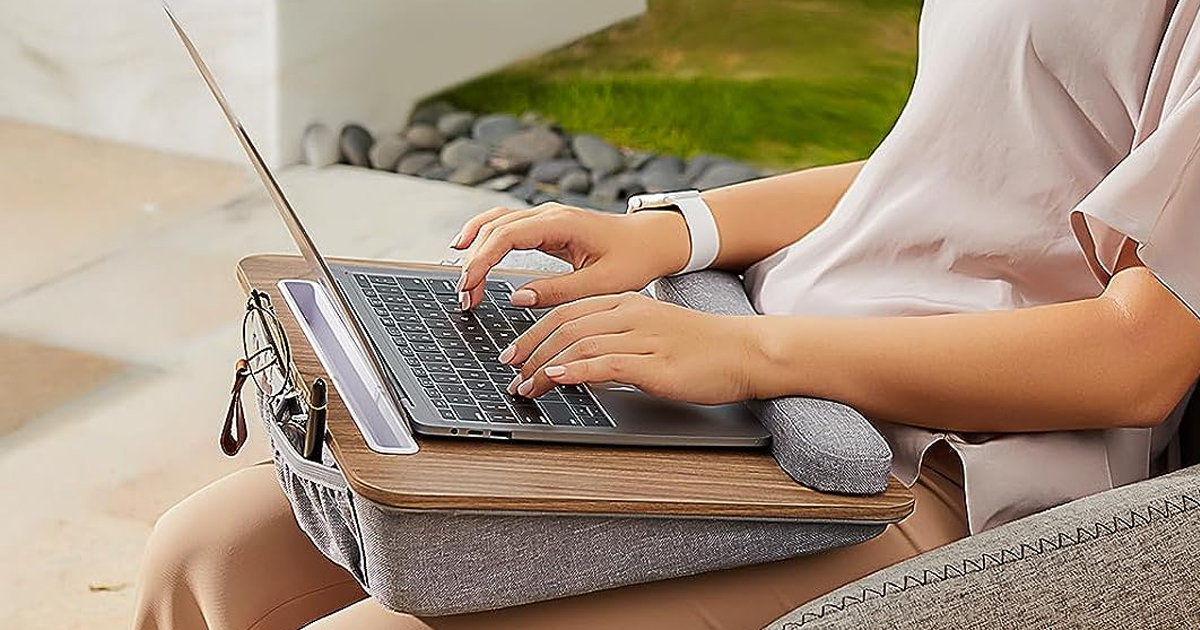 woman using laptop on laptop desk