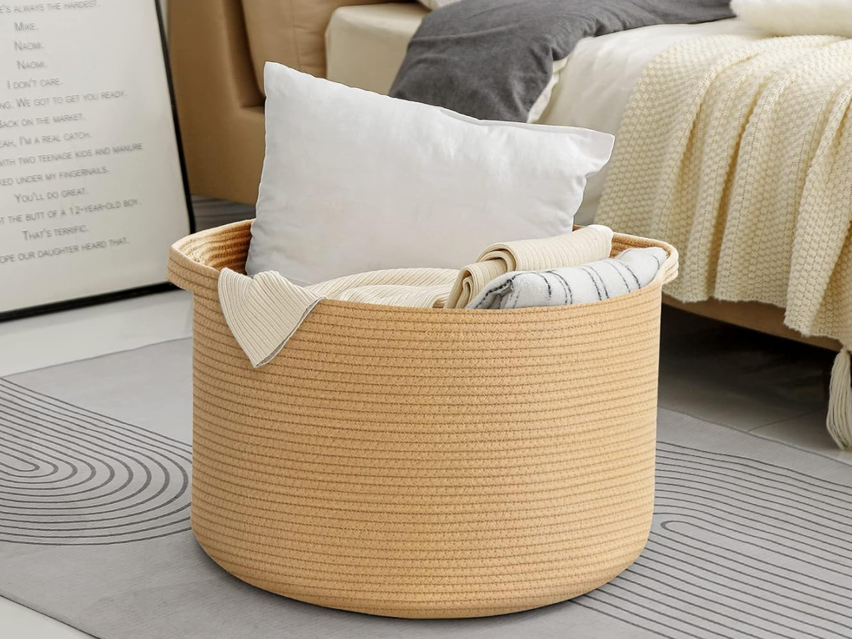 large basket filled with blankets and pillow