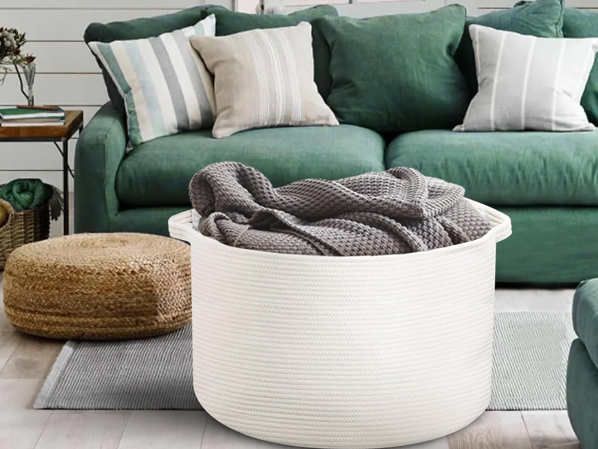 large basket in white filled with throw blanket