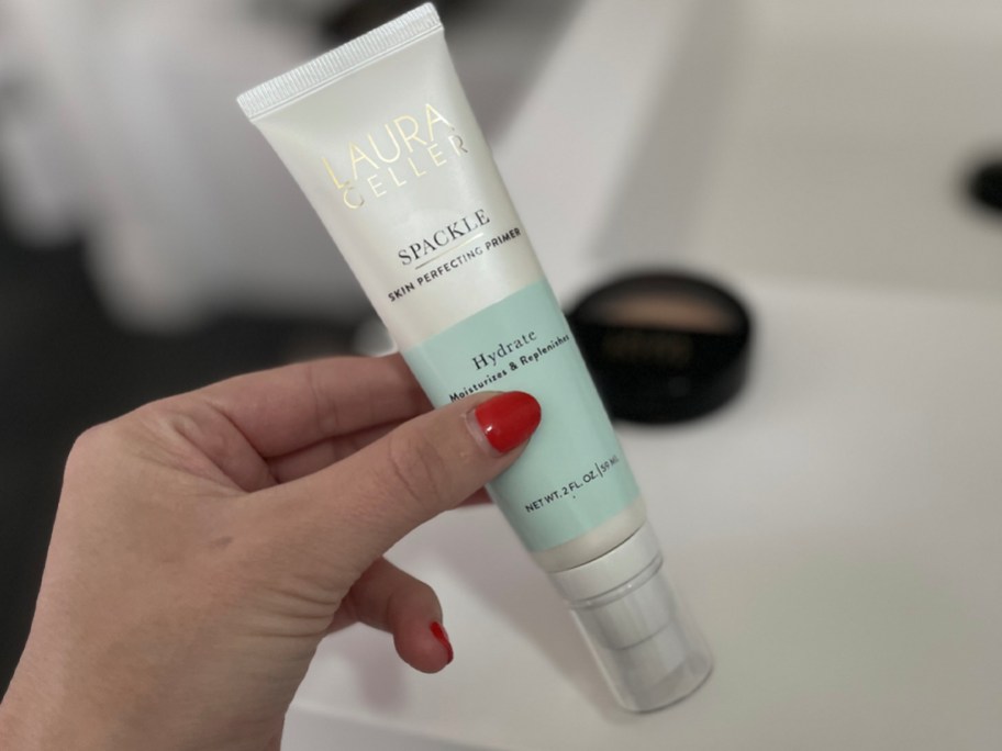 hand holding laura geller spackle