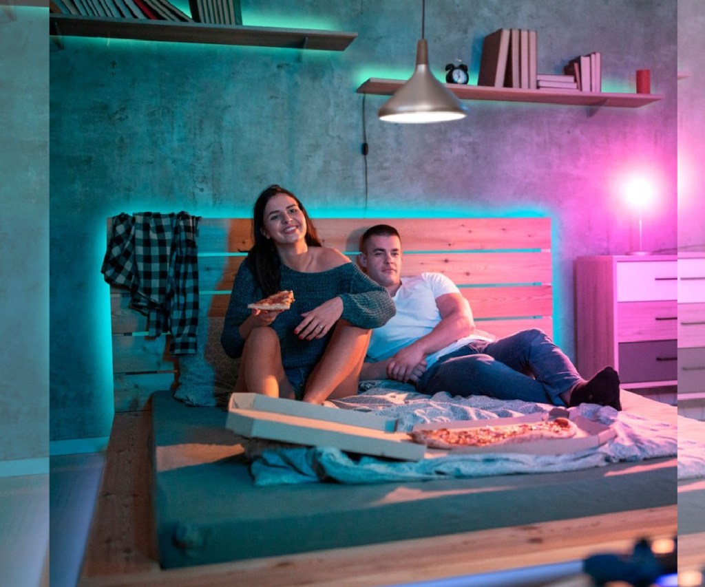 people sittting on bed with light strips