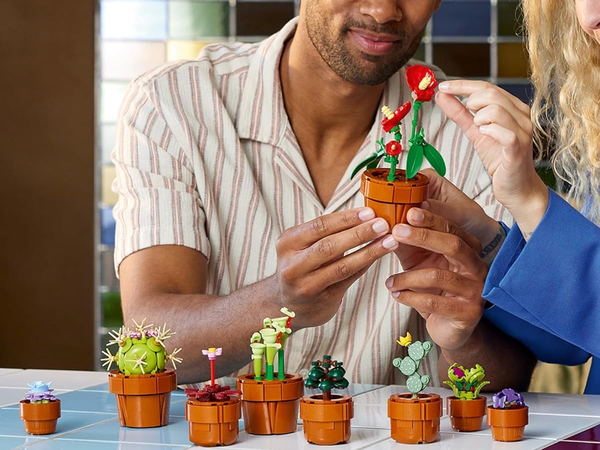 man and woman building LEGO tiny plants together
