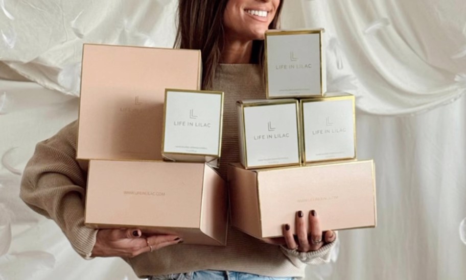 woman holding a bunch of life in lilac boxes