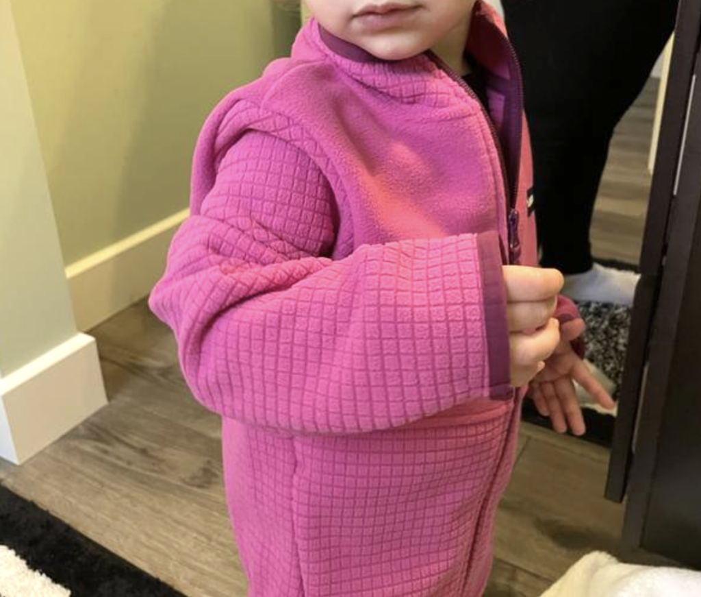 little girl wearing pink fleece 
