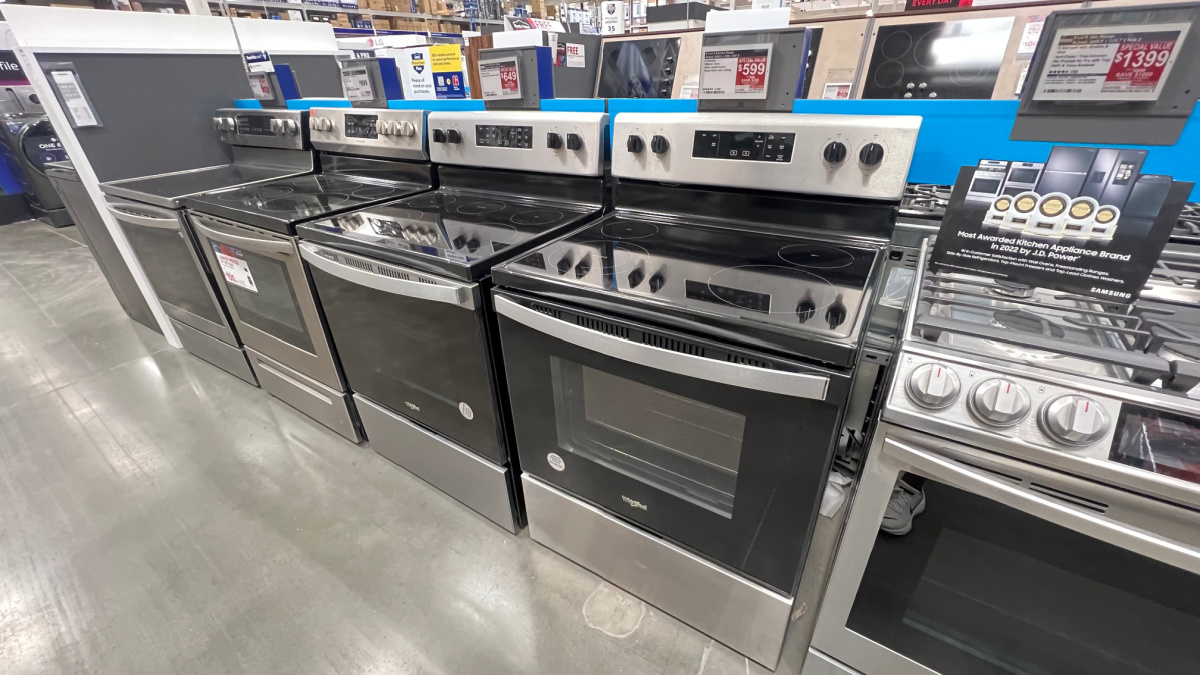 a row of stoves on display in a lowes store