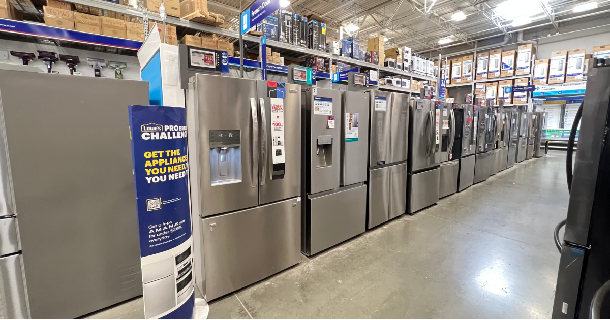 a row of refrigerators on display at lowes