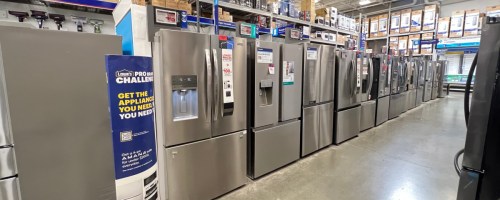 a row of refrigerators on display at lowes