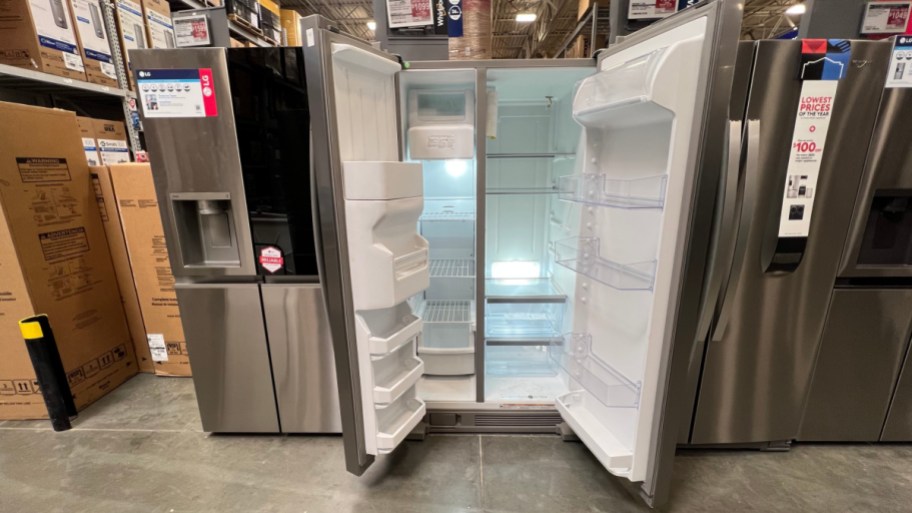 Open the whirlpool refrigerator on display in Lowe's S.