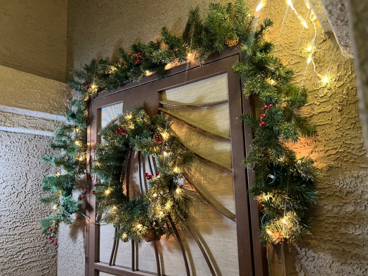 lighted wreath and swag above a door