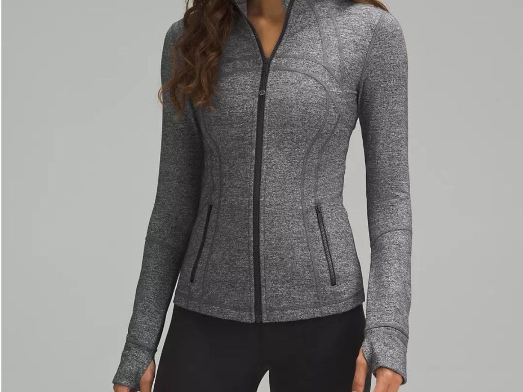 woman wearing gray zip up jacket