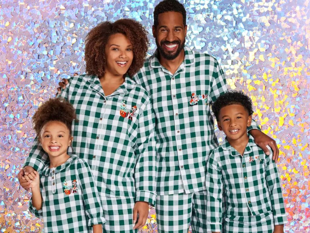 family wearing matching plaid disney pajamas