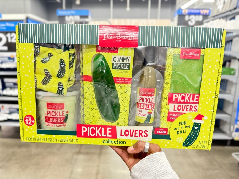 holding a boxed dill pickle gift set