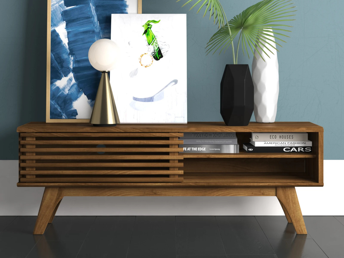mid century modern media console table with art and potted plants displayed on top