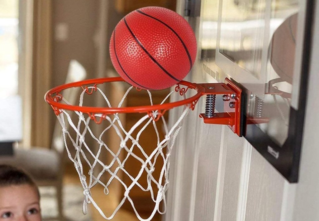 close up of basketball going into Mini Indoor Basketball Hoop hanging on indoor door