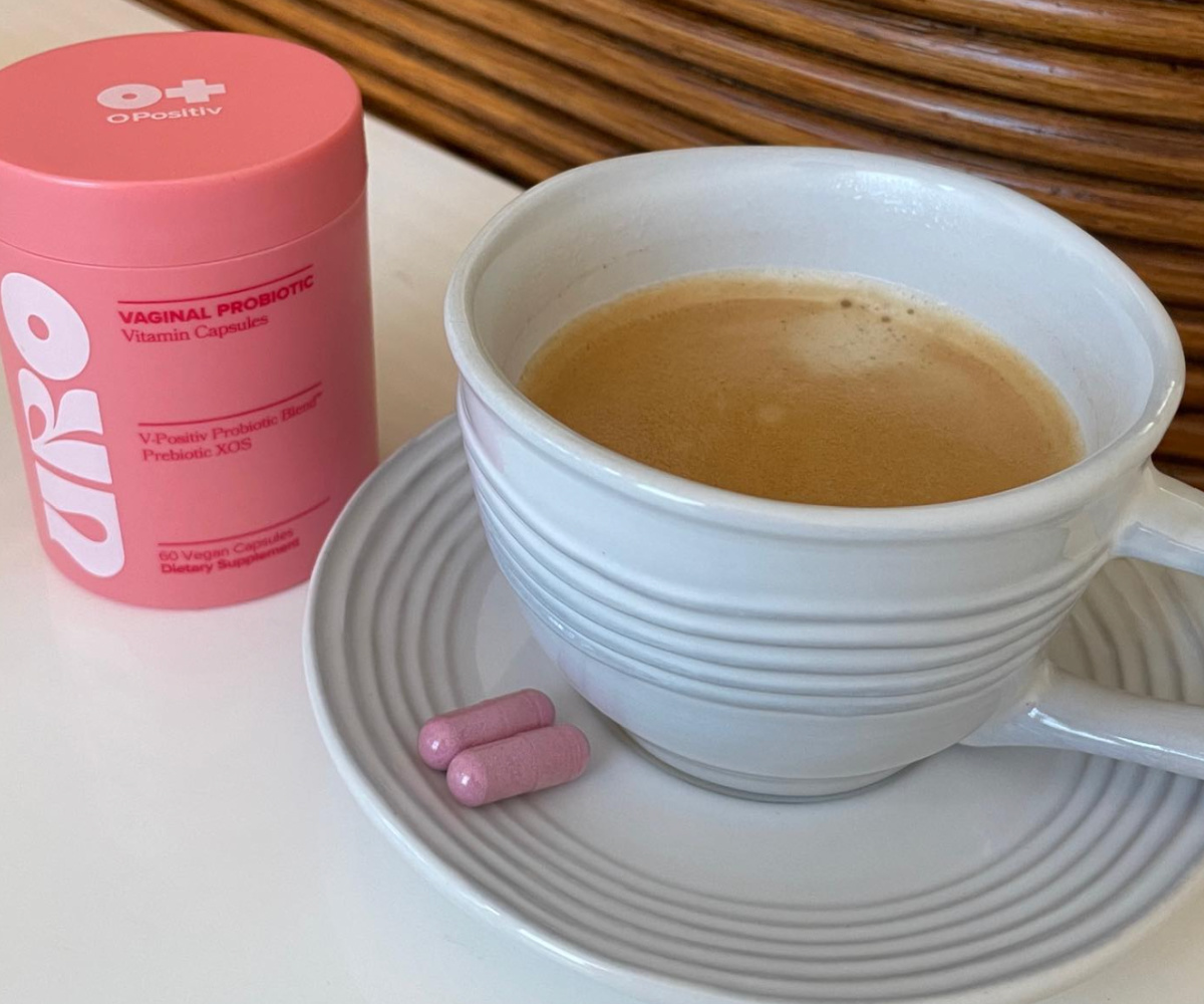 vitamins next to coffee cup