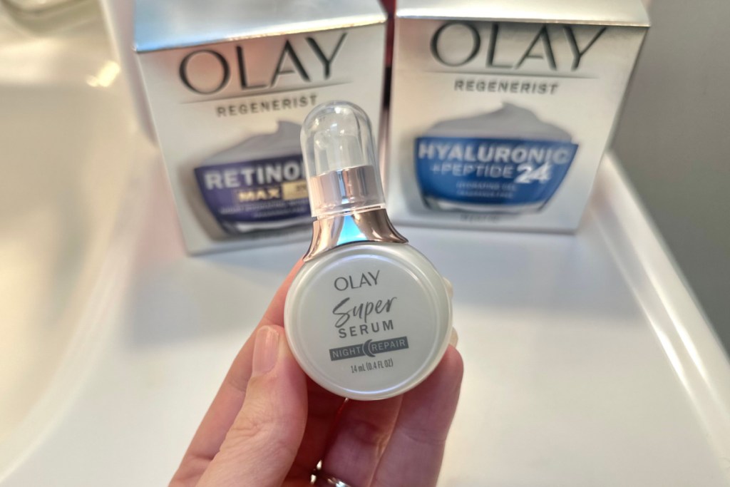 hand holding olay night serum mini size