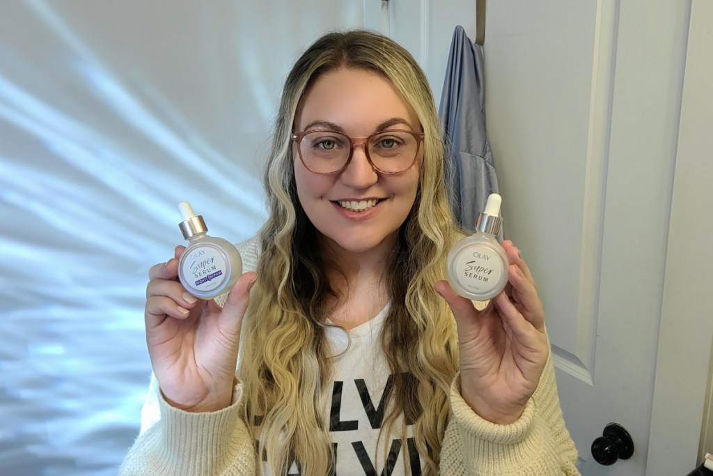 woman holding two serums