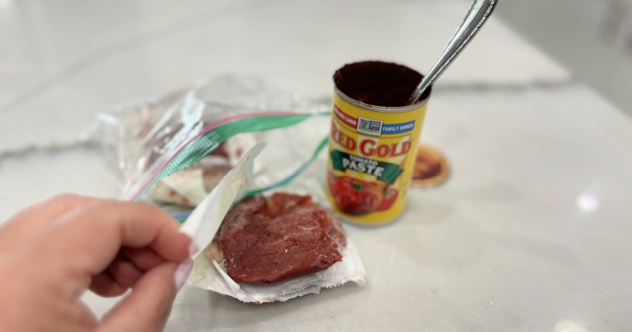 opening frozen tomato paste, one of our favorite food hacks for the kitchen