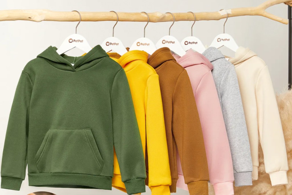 many colorful hoodies hanging on branch