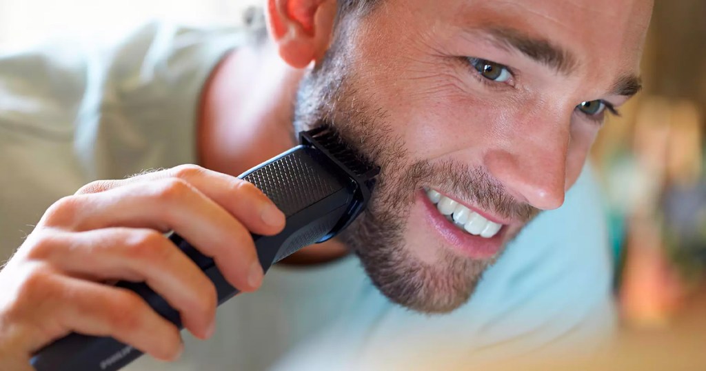 man using black beard trimmer