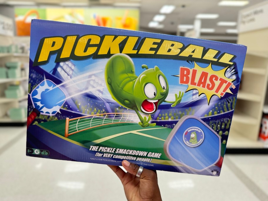 holding a tabletop pickleball game