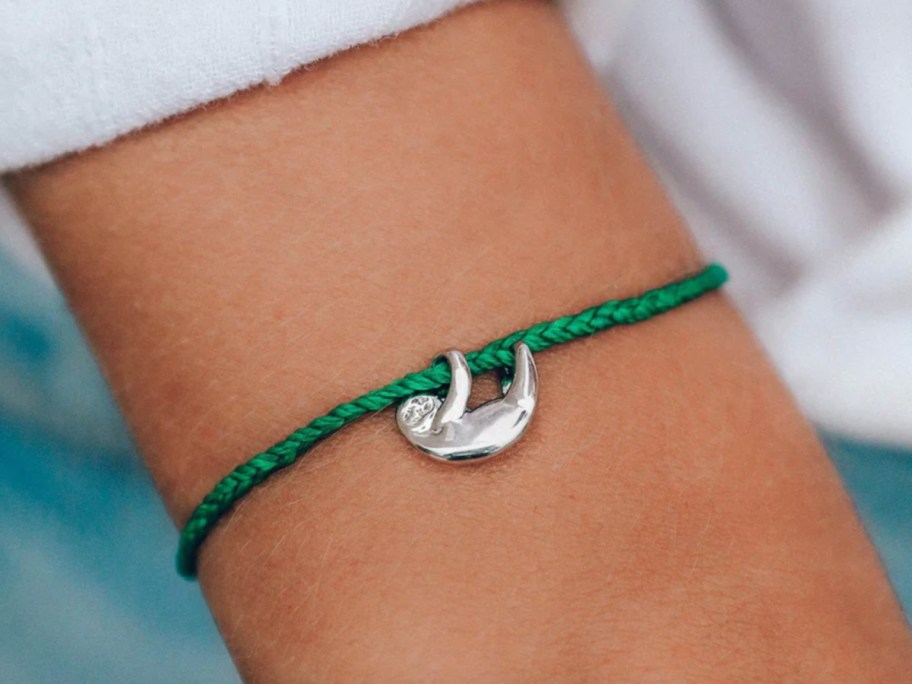 green sloth bracelet on wrist